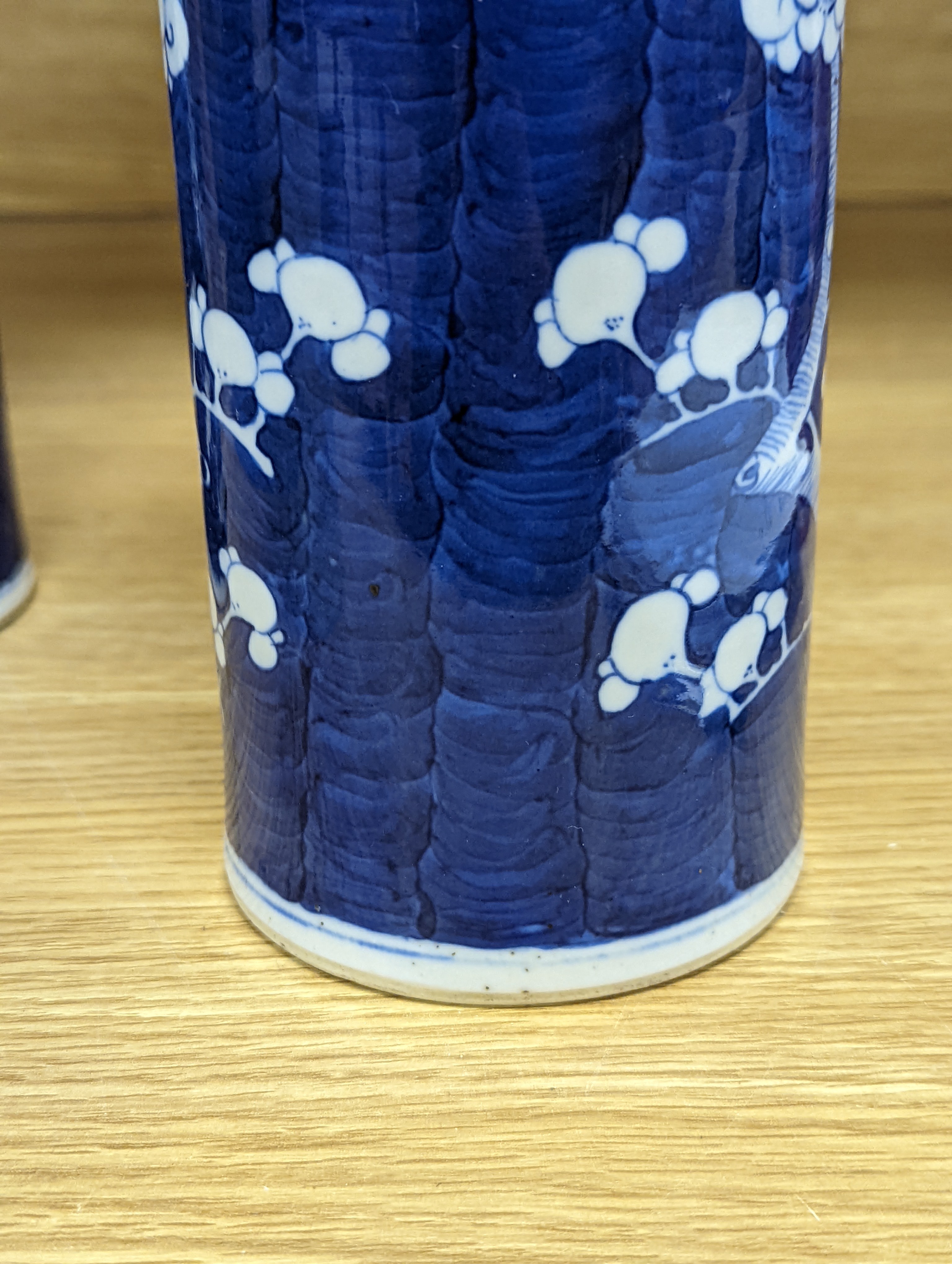 An 18th century Chinese famille rose mug, a Chinese Imari tea caddy and two Chinese blue and white sleeve vases 30cm (4)